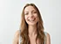 Beautiful sincere happy girl smiling laughing looking at camera over white background.